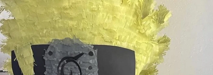 Close-up of cut yellow tissue paper forming a pi&ntilde;ata's spiked hair