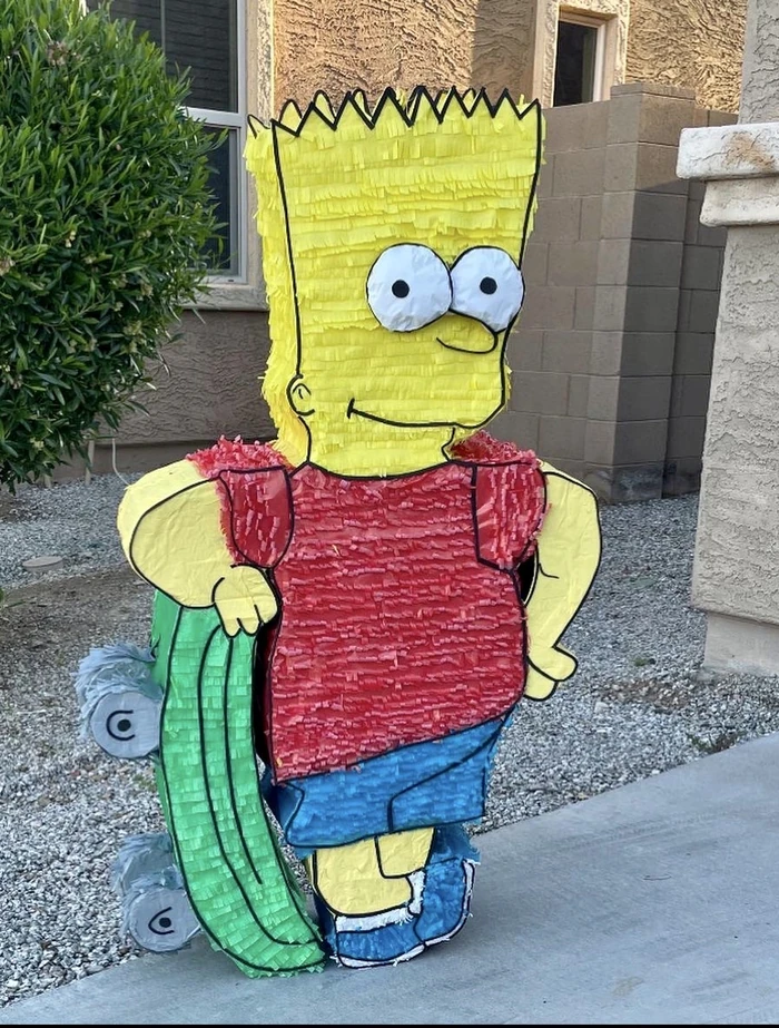 A life-size cartoon-boy pi&ntilde;ata with yellow spiked hair, photographed outdoors